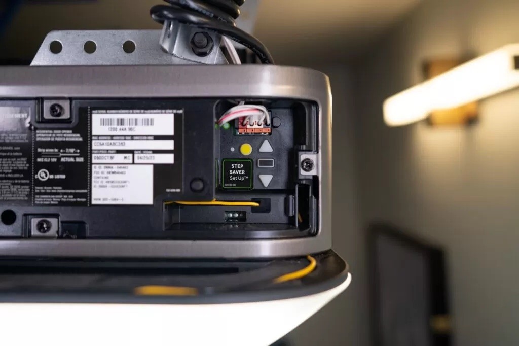 Garage door opener programming panel with a Learn button and adjustment controls